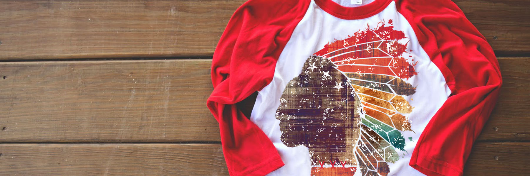 Red and white raglan shirt with Native American silhouette design.