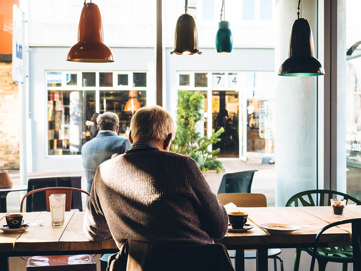 Man sitting alone in cozy coffee shop.