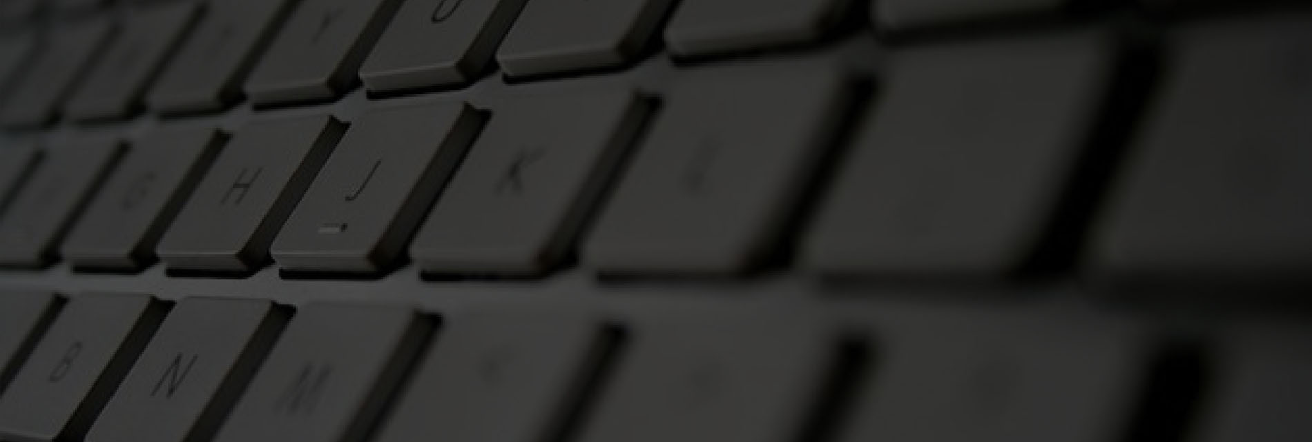 Close-up of a blurred computer keyboard with focus on a few keys.