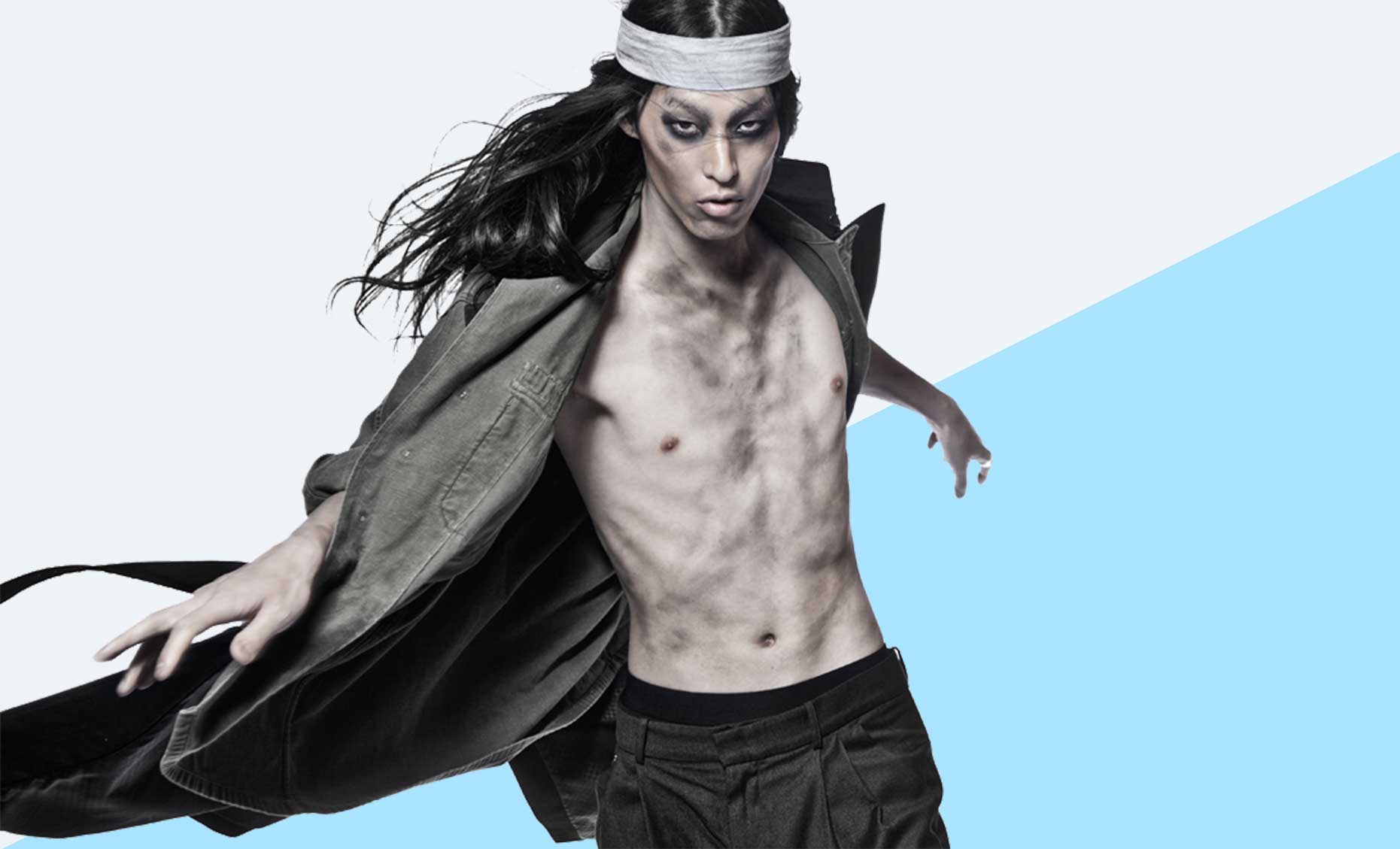 Model with long hair and headband posing.