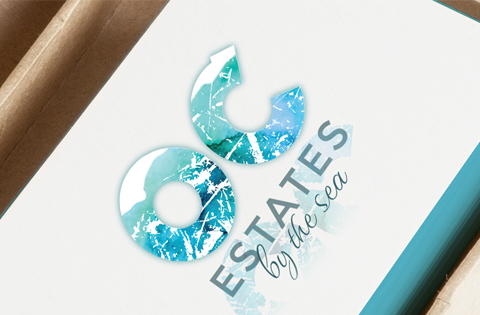 Logo for Estates by the Sea with oceanic design elements.