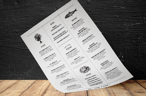 A restaurant menu with sections for meat, fish, and salads on a wooden floor background.