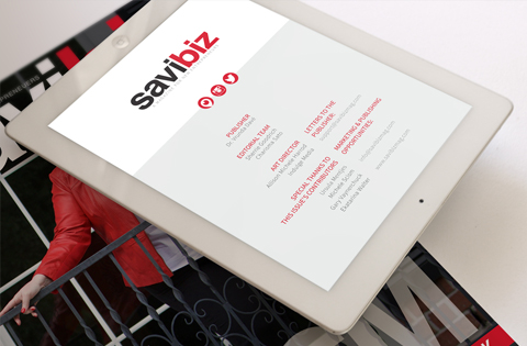 Tablet displaying a Sawbiz website page on a white surface.