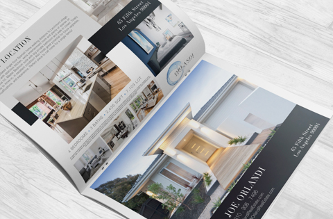 Open real estate brochure displaying modern home designs and interiors.