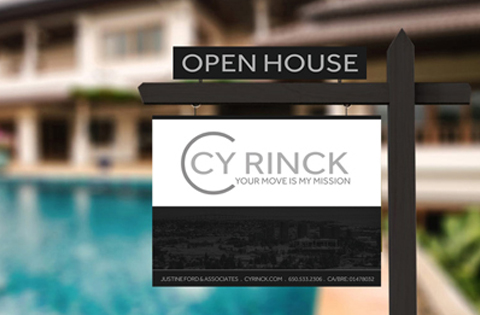 Open house sign with real estate branding by a pool.