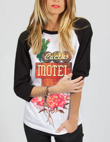 Woman wearing a cactus motel graphic shirt with floral design.