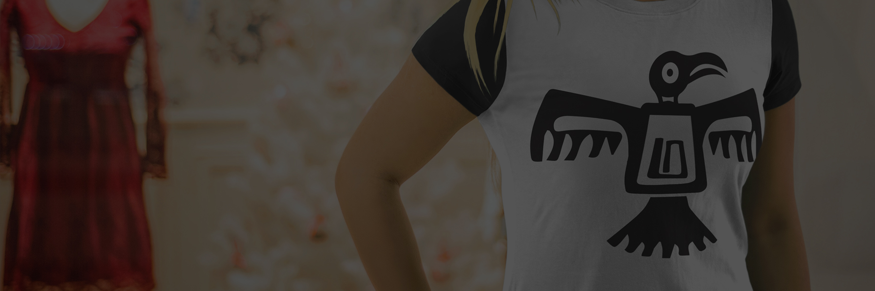 Person wearing a white and black t-shirt with a black eagle design.