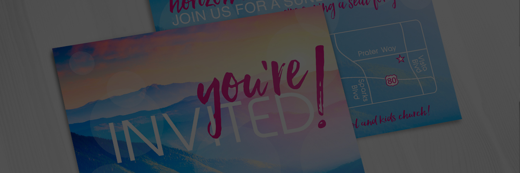 Close-up of colorful invitation cards with bold text.