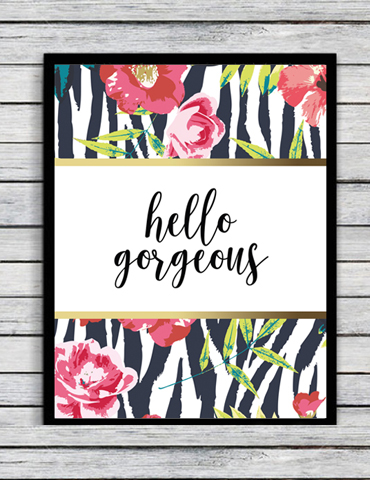 Framed print with floral and zebra pattern saying 'hello gorgeous'.