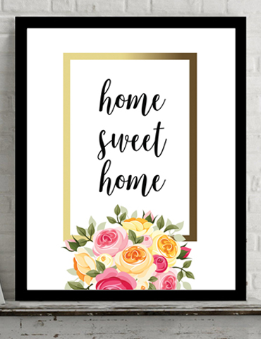 Framed wall art with 'home sweet home' text and floral decorations.