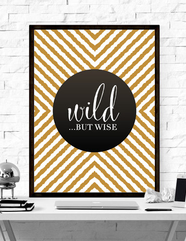 Decorative sign with the phrase 'wild... but wise' on a geometric background.