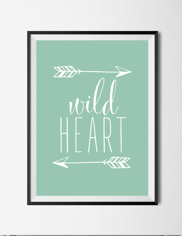 Framed wall art with 'wild HEART' text and arrows on a mint green background.