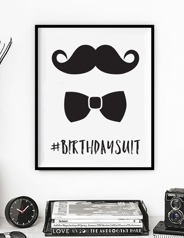 Framed print with mustache, bow tie, and #BIRTHDAYSUIT text.