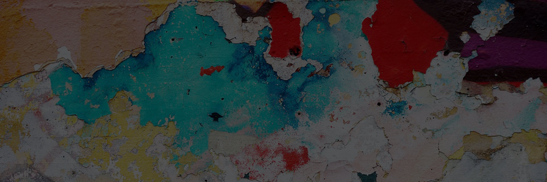 A textured wall with peeling paint in blue, red, and white colors.