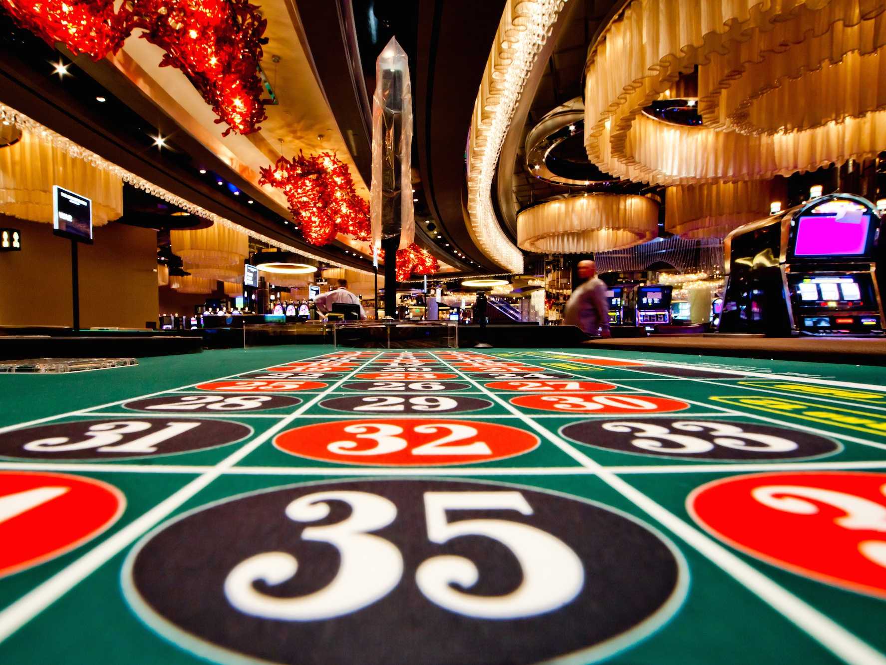 Casino roulette table with vibrant lights.