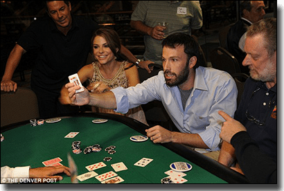 Group playing poker at a casino table.